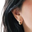 Model Wearing Small Chunky Huggie Hoop Earrings in Gold