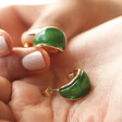 Model Holding Small Green Resin Hoop Earrings in Gold