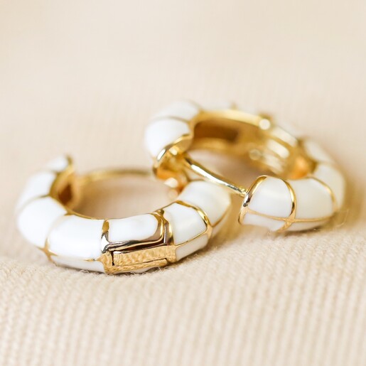 White Geometric Enamel Hoop Earrings in Gold on Fabric