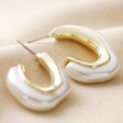 Close-up of White Molten Pearlescent Hoop Earrings in Gold