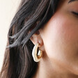 Model Wearing White Molten Pearlescent Hoop Earrings in Gold