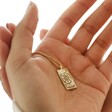 Model Holding Fortune Tarot Enamel Pendant Necklace in Gold