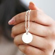 model holding Disc and Figaro Chain Necklace in Silver