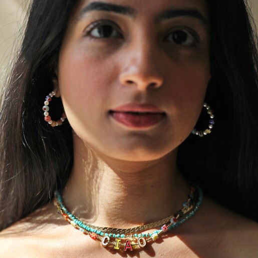 Model Wearing Necklaces Layered with Millefiori Bead Ciao Necklace