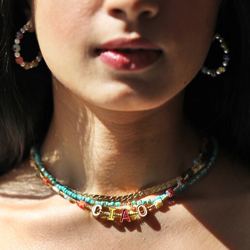 Close Up of Model Wearing Millefiori Bead Ciao Necklace with Other Necklaces and Earrings