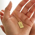 Model Holding Personalised Enamel Tarot Card Necklace in Gold