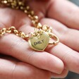 Model Holding Personalised Round Clasp and Hoop Necklace in Gold