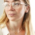 model with glasses wearing Round Clasp and Pearls Necklace in Gold