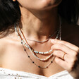 Model Wears Stainless Steel Long Starry Necklace in Silver Layered with Other Necklaces