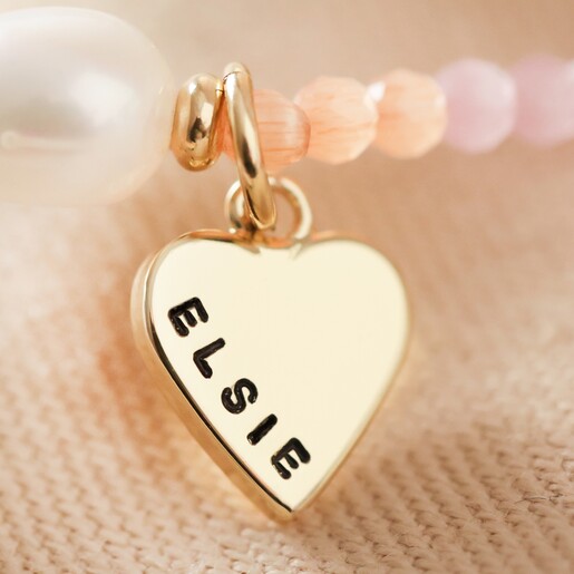 close up of small gold hand stamped heart charm