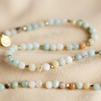 Semi-Precious Stone Beaded Necklace in Pastel Green on fabric background