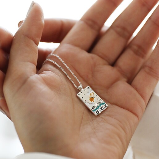 Model Holding The Star Tarot Enamel Pendant Necklace in Silver