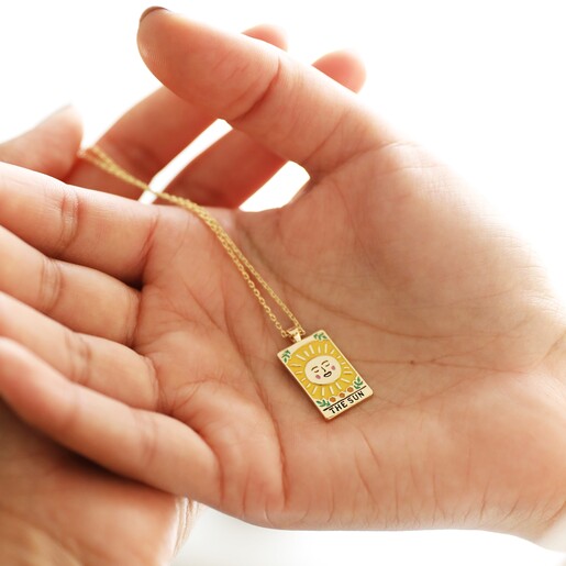 Model Holding The Sun Tarot Enamel Pendant Necklace in Gold