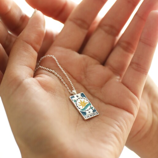 Model Holding The World Tarot Enamel Pendant Necklace in Silver