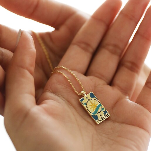 Model Holding The World Tarot Enamel Pendant Necklace in Gold