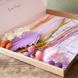 Colourful Springtime Cut Dried Flowers Letterbox Gift in packaging sat on a wooden table