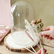 model holding stems of dried flowers included in Blooming Lovely Dried Flower Cloche Kit