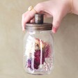 Model Holding Dried Flowers Candle Jar