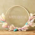 happy easter Easter Dried Flower Bamboo Hoop Wreath lent against green wall