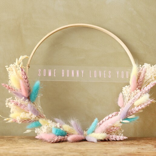 some bunny loves you Easter Dried Flower Bamboo Hoop Wreath lent against green wall