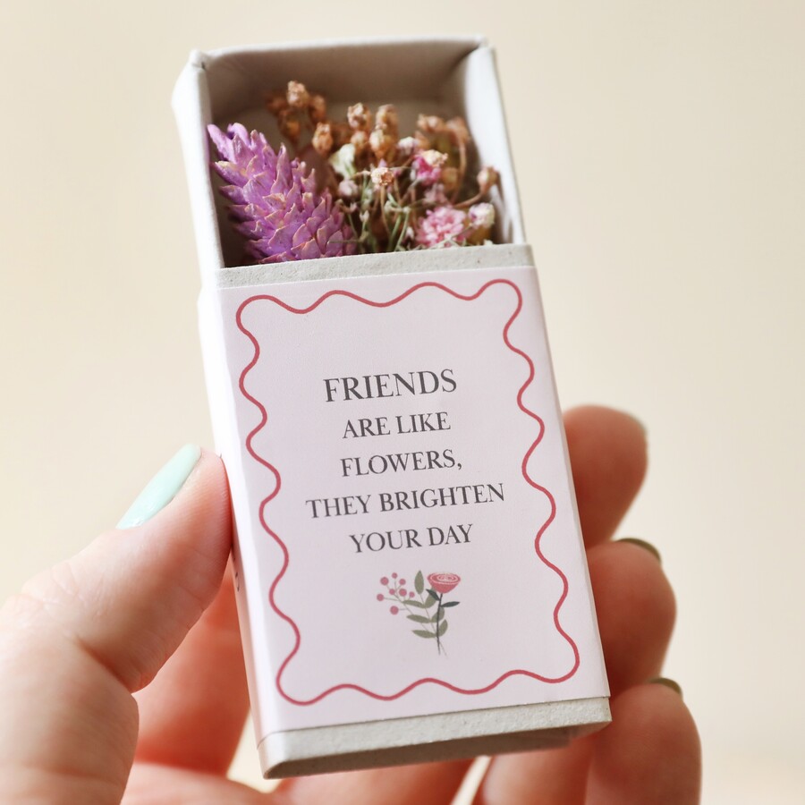 model holding Friend Tiny Matchbox Dried Flower Posy against beige background