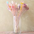 Pastel Easter Dried Flower Bouquet in clear vase sat on wooden table