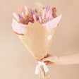 Model Holding Pink and Purple Dried Flower Bouquet
