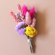 Rainbow Brights Dried Flower Buttonhole Against Neutral Background