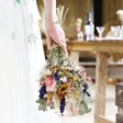 Model Holding Summer Meadow Dried Flower Wedding Bouquet Upside Down