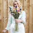 Model Holding Summer Meadow Dried Flower Wedding Bouquet Towards Camera