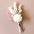 Vintage Pink Dried Flower Buttonhole Against Neutral Background