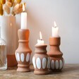 Set of 3 Terracotta Candlestick Holders with Lit Candles