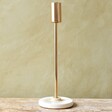 Small Gold Candlestick Holder with Glazed Base on Wooden Table
