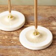 Close Up of Gold Candlestick Holders with Glazed Bases