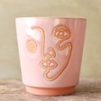 front of Small Pink and Terracotta Abstract Face Planter, H12cm