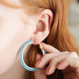 Model WearingAqua Blue Beaded Gold Hoop Earrings