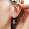 Blue Teardrop Drop Earrings in Gold on Model