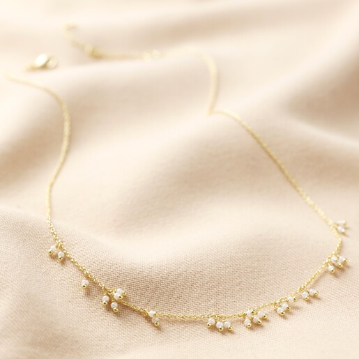 Full Length Shot of Chain and Pearl Cluster Necklace in Gold