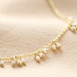 Chain and Pearl Cluster Necklace in Gold on Beige Linen