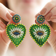 Green Bead Heart Drop Earrings Being Held