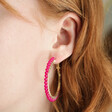Model Wearing Hot Pink Beaded Gold Hoop Earrings