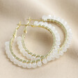 Ice White Beaded Gold Hoop Earrings on Beige Fabric