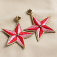Candy Pink Star Earrings on White Surface