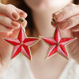 Model Holding Pink and Red Embroidered Star Drop Earrings