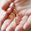 Model Holding Pink Teardrop Drop Earrings