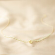 Sage Green Bead Gold Necklace on White Fabric