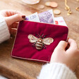 Model Holding Velvet Beaded Bee Coin Purse in Magenta
