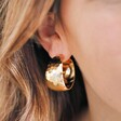 Wide Hammered Hoop Earrings in Gold on Model