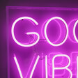 Close Up of Good Vibes Only Neon LED Wall Light in Pink Lit Up