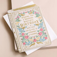 Vintage Novel Blooming Beautiful Birthday Card  Laying on White Envelope on Pink Background